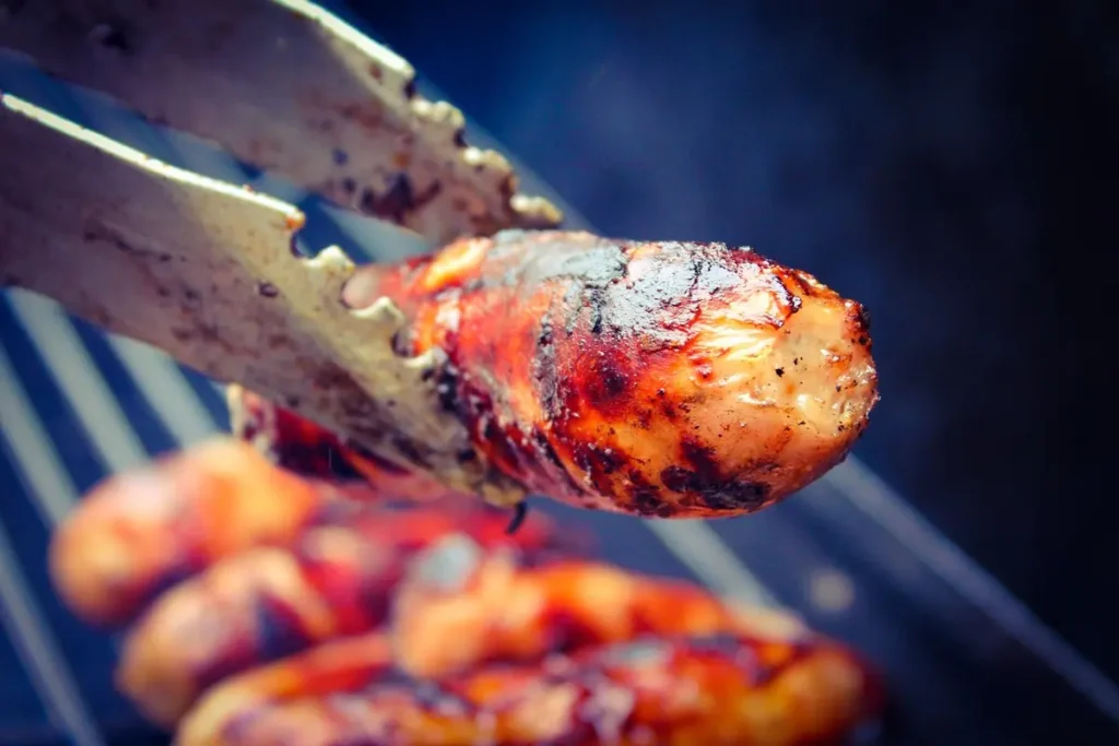 Golden-brown oven-baked sausages on a serving platter.