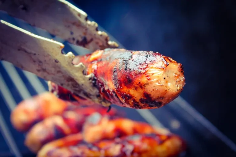 Golden-brown oven-baked sausages on a serving platter.
